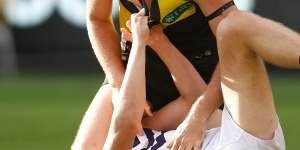 Jye Amiss of the Dockers and Ben Miller of Richmond wrestle during Sunday’s match.