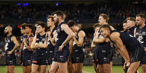 For the want of a behind,a season lost:dejected Carlton look on.