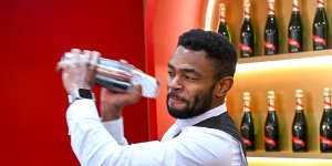 A bartender serves champagne in the ‘Théâtre G.H. Mumm’ marquee.