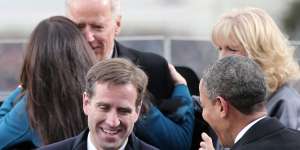 Beau Biden,carries the family Bible after his father was sworn in as US vice-president for the second time in January 2013.