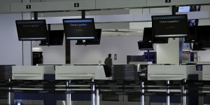 Closed check-in counters in the departure terminal at Sydney international airport.