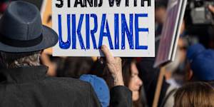 A demonstrator holds a poster reading “Real Americans Stand with Ukraine” during a rally to protest US President Donald Trump’s policies on Monday.