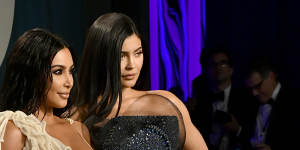 Kylie Jenner (right,with Kim Kardashian) has become one of the family's highest earners after selling a majority stake in her cosmetics business.