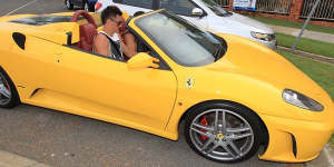 Bernard Tomic driving his yellow Ferrari back in 2014.