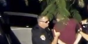 A still image in video from WSVN.com shows a man,named as Nikolas Cruz,being placed in handcuffs bypolice near Marjory Stoneman Douglas High School.