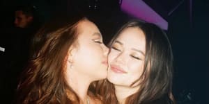 Little sister Chloe Murdoch gives Grace Murdoch a kiss at her 21st birthday celebrations in New York last week.