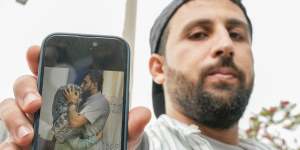 Kassem Abo Zeed holds up a phone displaying a photo of himself with his wife,Ezra – who is missing after a fishing boat carrying migrants sank off southern Greece – in the southern port city of Kalamata.