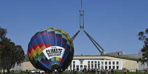 A climate change rally sets up outside Parliament House on Tuesday.