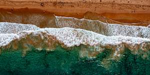 Beachgoers enjoy the crystal clear waters at Palm Beach.