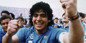 Maradona cheers after the Napoli team clinched their first Serie A title in 1987.