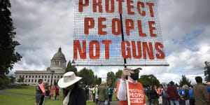 A protester stands with other gun-control advocates during a rally at the state Capitol in Olympia,Washington over the weekend. 