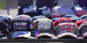 Hats reading,“God,Guns and Trump” and “Jesus is my saviour,Trump is my president” are sold at a campaign rally.
