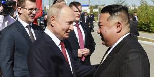 Russian President Vladimir Putin greets and North Korea’s leader Kim Jong-un.