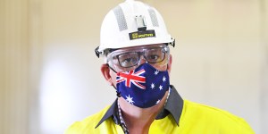 Prime Minister Scott Morrison wears a hard hat and face mask during a visit to South32 Cannington Mine in McKinlay,Queensland on Wednesday.