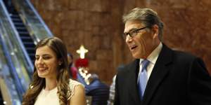 Former Texas governor Rick Perry enters Trump Tower with Trump aide Madeleine Westerhout in 2016.