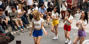 Young Korean women dance to K-Pop in Hongdae,a hip district popular with students.