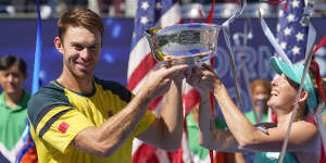 John Peers,left,and Storm Sanders,of Australia,hold up the championship trophy after winning the mixed doubles final against Kirsten Flipkens,of Belgium,and Edouard Roger-Vasselin,of France,at the U.S. Open.