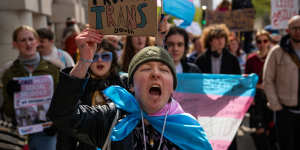 Trans rights activists take part in a protest against the ban on hormone blockers in London.