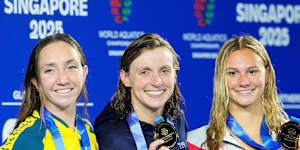 800m freestyle gold medallist Katie Ledecky of the United States,centre,flanked by silver medallist Lani Pallister of Australia,left,and bronze medallist Summer McIntosh of Canada,right.
