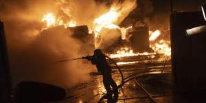 Firefighters extinguish a fire after a Russian attack on a residential neighborhood in Kharkiv,Ukraine.