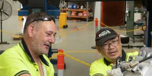 Garry Clerkes and Dzung Huynh,at SEA-Electric’s plant in Dandenong,where the company installs electric engines in utes and other commercial vehicles. 