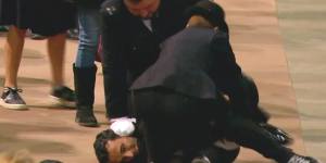 A screen grab of police restraining the man.
