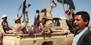 In this photo from January,tribesmen loyal to Houthi rebels chant slogans during a gathering aimed at mobilising more fighters into battlefronts to fight pro-government forces,in Sanaa,Yemen. 