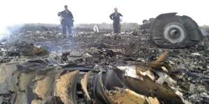 Emergencies Ministry members work at the site of a Malaysia Airlines Boeing 777 plane crash in the settlement of Grabovo in the Donetsk region.