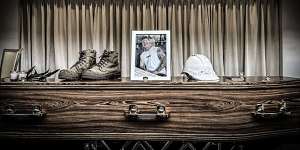 Ben Nash’s work gear rests atop his coffin. 