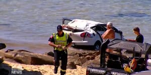 Three people injured after car drives off cliff onto Newcastle beach