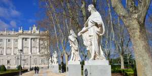 Madrid’s Plaza de Oriente with statues and Royal Palace.