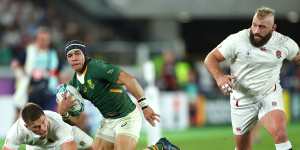 Cheslin Kolbe breaks through the tackle of Owen Farrell of England to score.
