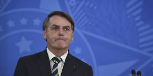 Brazilian governors and health authorities are at odds with President Jair Bolsonaro,above. Bolsonaro has called the pandemic a momentary,minor problem,saying strong measures to contain it are unnecessary.