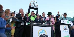 Sam Clipperton lifts the Everest trophy after Think About It’s victory at Randwick on Saturday. 