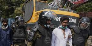 Police detain supporters of former prime minister Imran Khan during a search operation in the Khans’ residence,in Lahore,Pakistan,on Saturday.