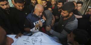 Al Jazeera journalist Wael Dahdouh holds the hand of his son Hamza,who also worked for Al Jazeera and who was killed in an Israeli airstrike in Rafah,Gaza Strip.
