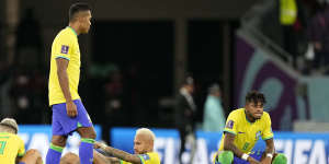 Brazil’s Neymar,center,and his team mates react after the penalty shootout.