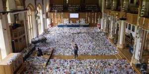 Captain Tom's grandson Benjie stands in the Great Hall of Bedford School where more than 125,000 birthday cards have been sent from around the world.