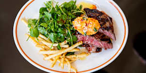 Grilled-and-sliced black angus rib eye topped with tomato butter with a good handful of watercress.