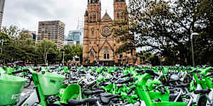 Masses of Lime and other e-bikes in a large fenced off area in front of the Catholic cathedral near Hyde Park.