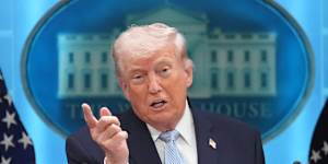 President Donald Trump speaks with reporters