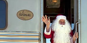 Cross our heart ... (from left) dining in the restaurant car;winding through the outback;Santa's a hit with children in Watson.