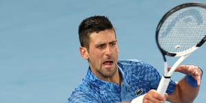 Novak Djokovic,with strapping on his left leg,on the way to beating Tommy Paul in their semi-final.