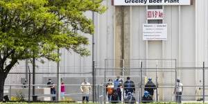 Employees exit from the JBS Beef Production Facility in Greeley,Colorado.