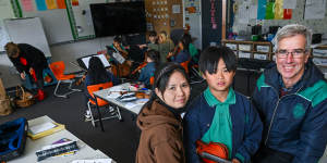 From left:Linh Nguyen with her son Kaien Vu and Sacred Heart School,principal Matthew Shawcross.