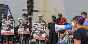 Anti-war protesters in Oakland lock themselves to a ladder of a ship they believe to be transporting military supplies to Israel.