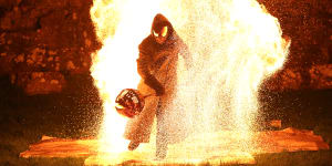 Dark rituals:the hooded-man emerges from the flames at Puca.