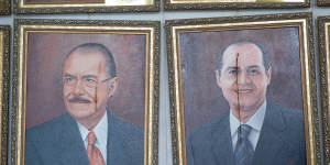 Damaged portraits of former Senate Presidents José Sarney and Renan Calheiros are seen at the Brazilian National Congress.