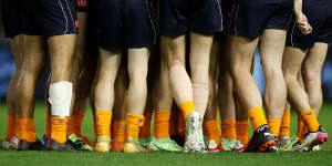 Blues players wear orange socks as part of the Carlton Respects campaign during the 2021 season.