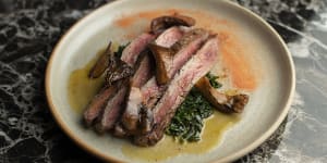 Wagyu flank from Jack's Creek is made autumnal with pan-roasted pine mushrooms and braised kale.